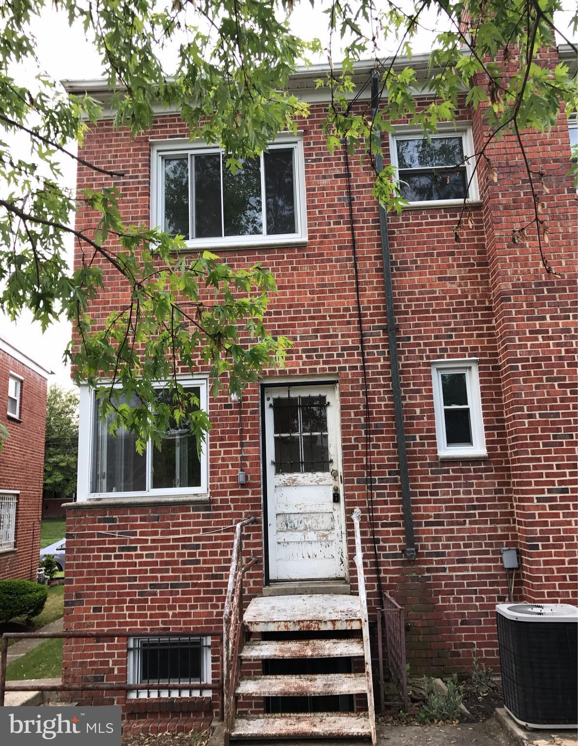 5051 Sargent Road Northeast Washington, DC 20017 - Photo 6 of 11 a front view of a house with a door