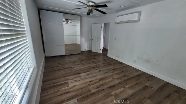 a view of a hallway with wooden floor and entryway
