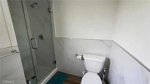 a bathroom with a toilet and a shower