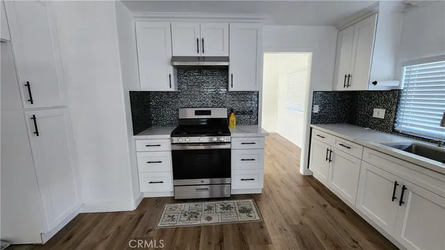 a kitchen with stainless steel appliances a stove a microwave and cabinets