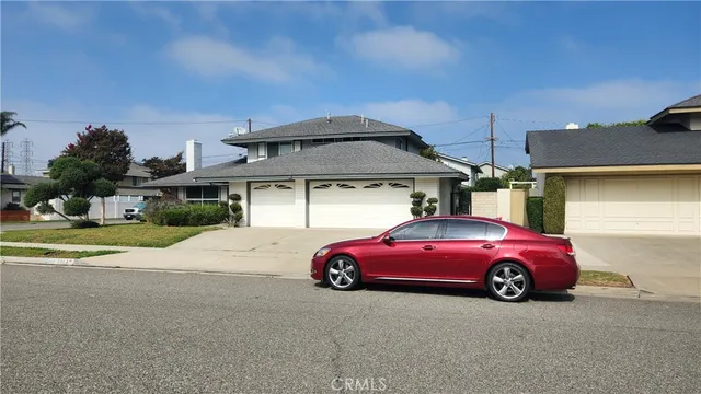 a front view of a house with parking space