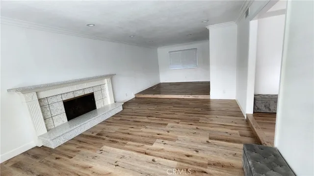 a view of a kitchen with wooden floor and a kitchen
