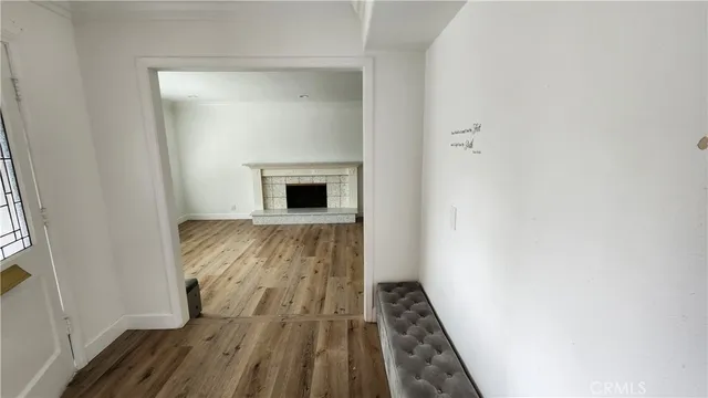 a view of an empty room with a fireplace and a window