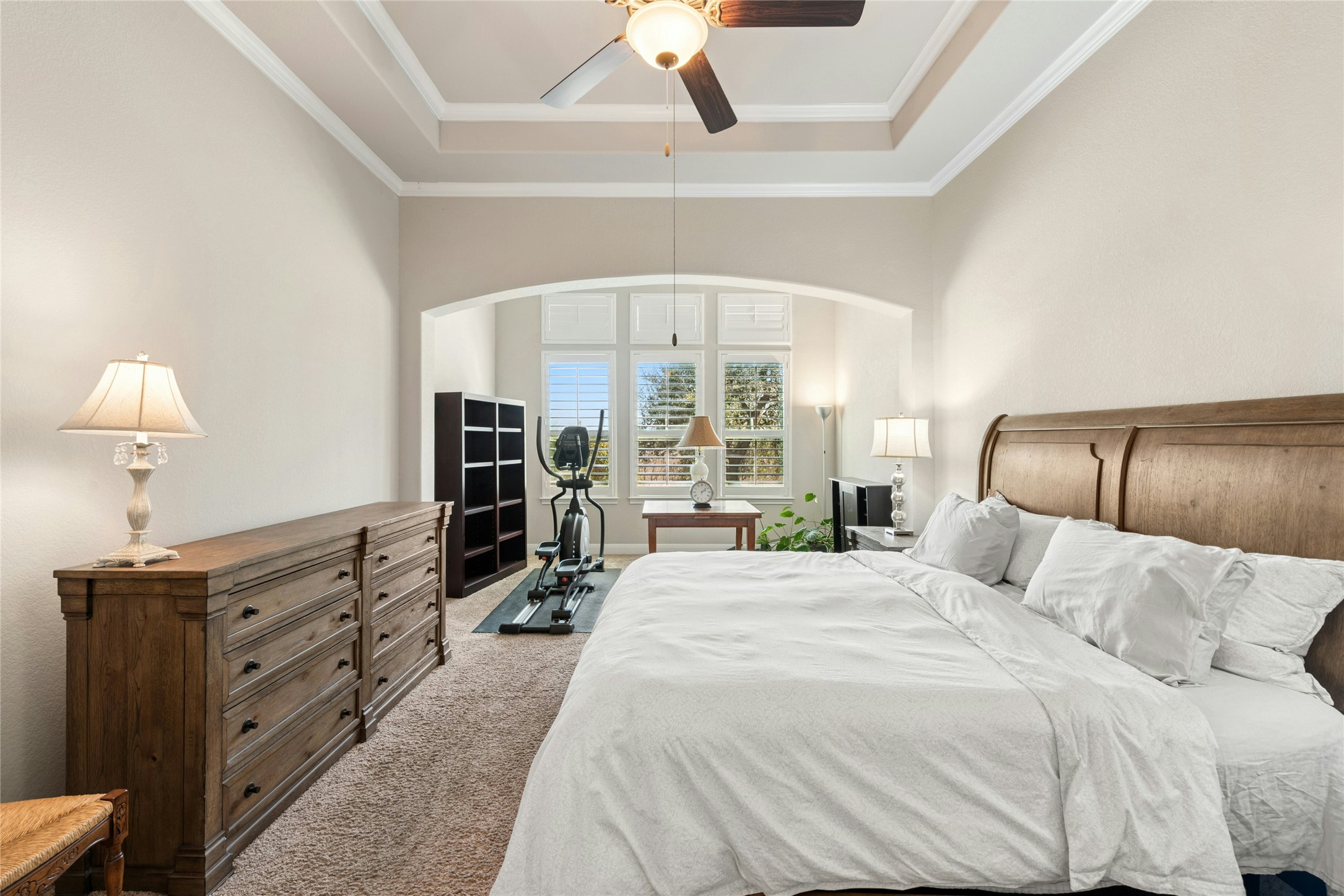 116 Evolutions Path Lakeway, TX 78738 - Photo 16 of 34 Bedroom with light colored carpet, a ceiling fan, and a tray ceiling