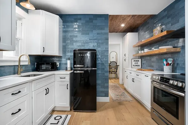 a kitchen with stainless steel appliances a stove and a refrigerator