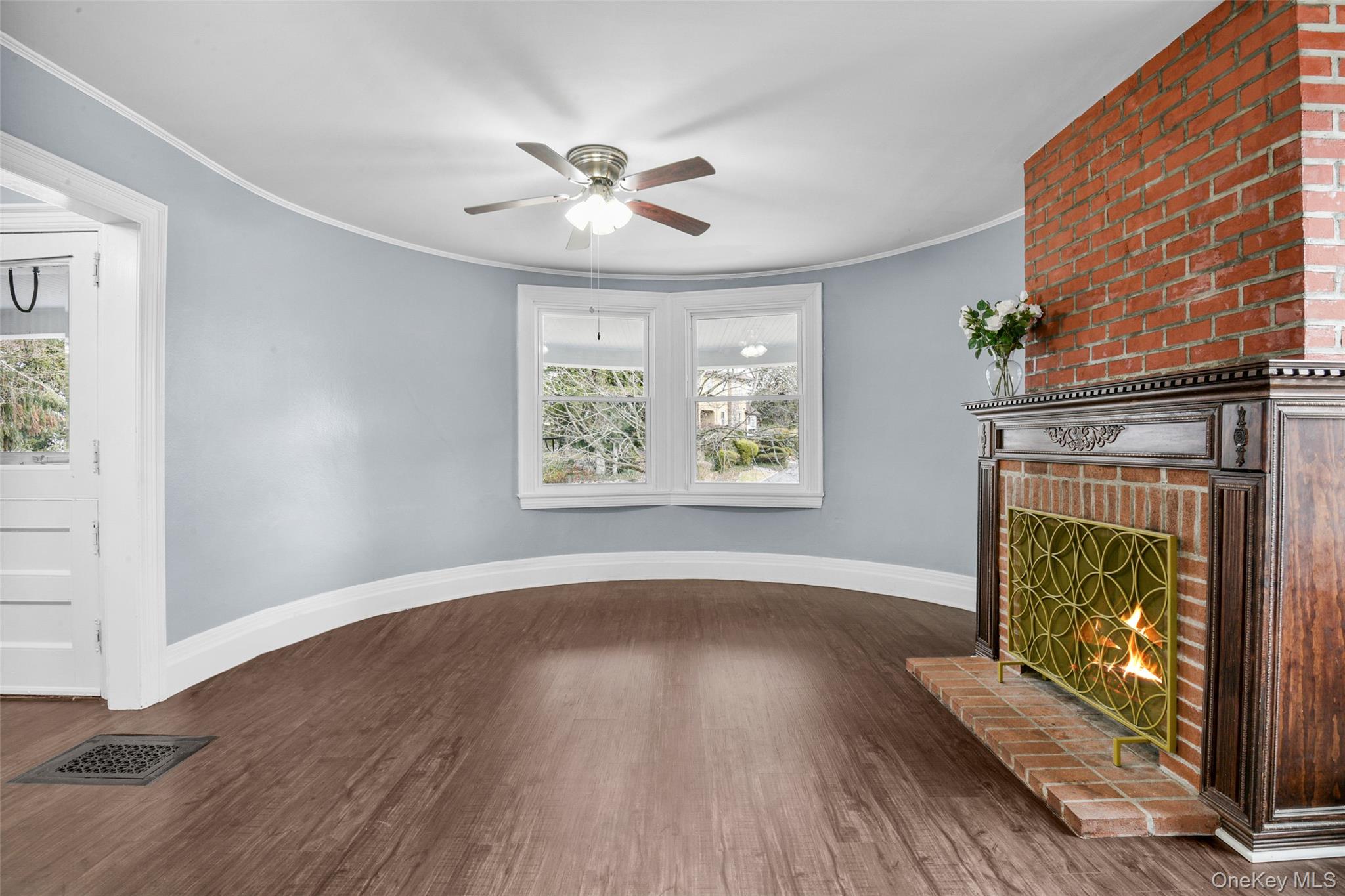 8 The Serpentine New Rochelle, NY 10801 - Photo 13 of 47 The living room and its fireplace