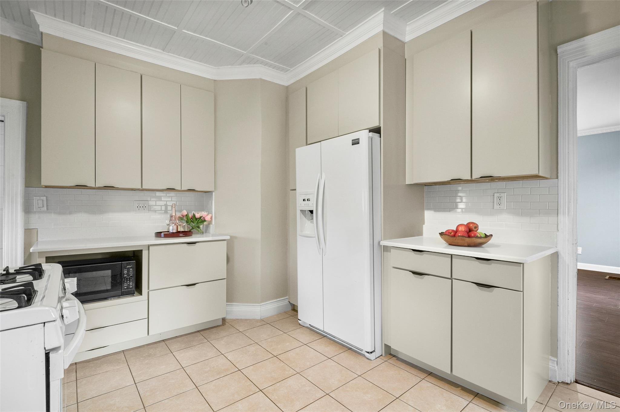 8 The Serpentine New Rochelle, NY 10801 - Photo 16 of 48 a kitchen with white cabinets and white appliances