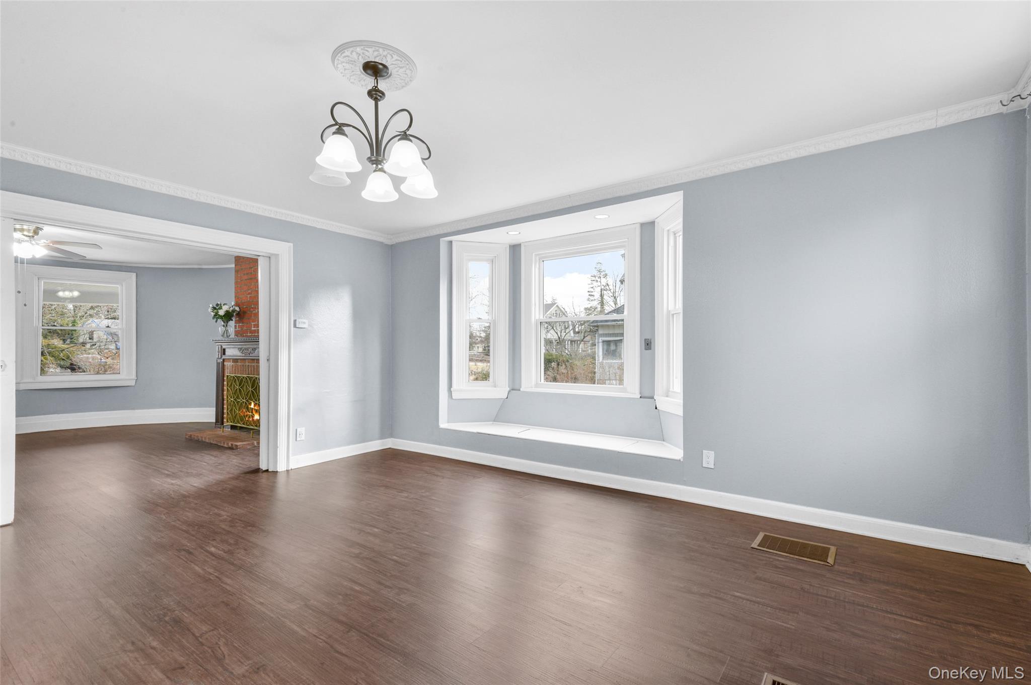 8 The Serpentine New Rochelle, NY 10801 - Photo 17 of 48 a view of an empty room with wooden floor and a window