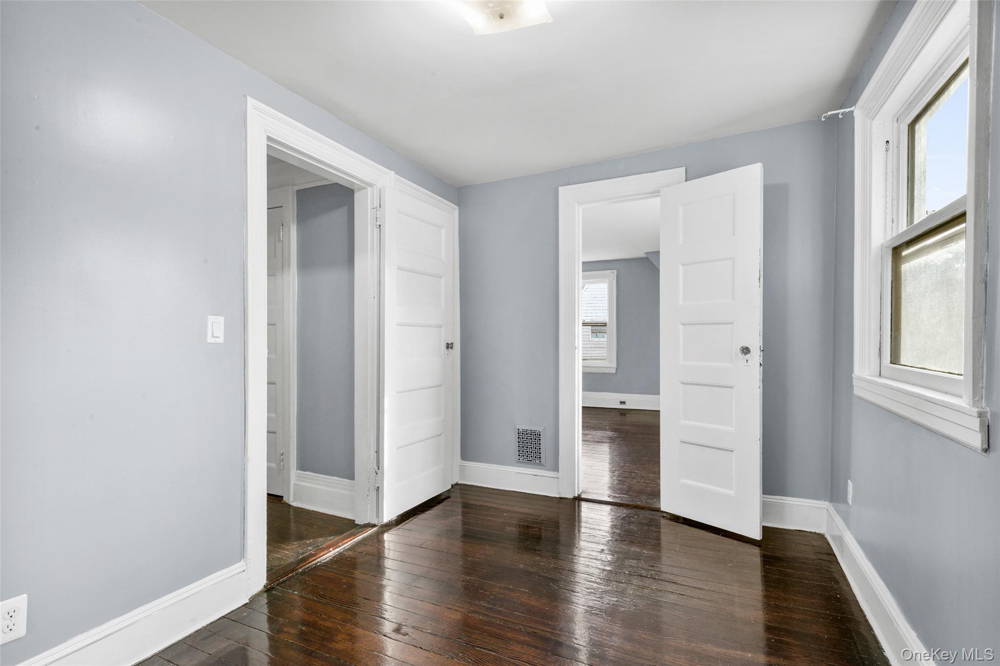 8 The Serpentine New Rochelle, NY 10801 - Photo 29 of 48 an empty room with wooden floor and windows