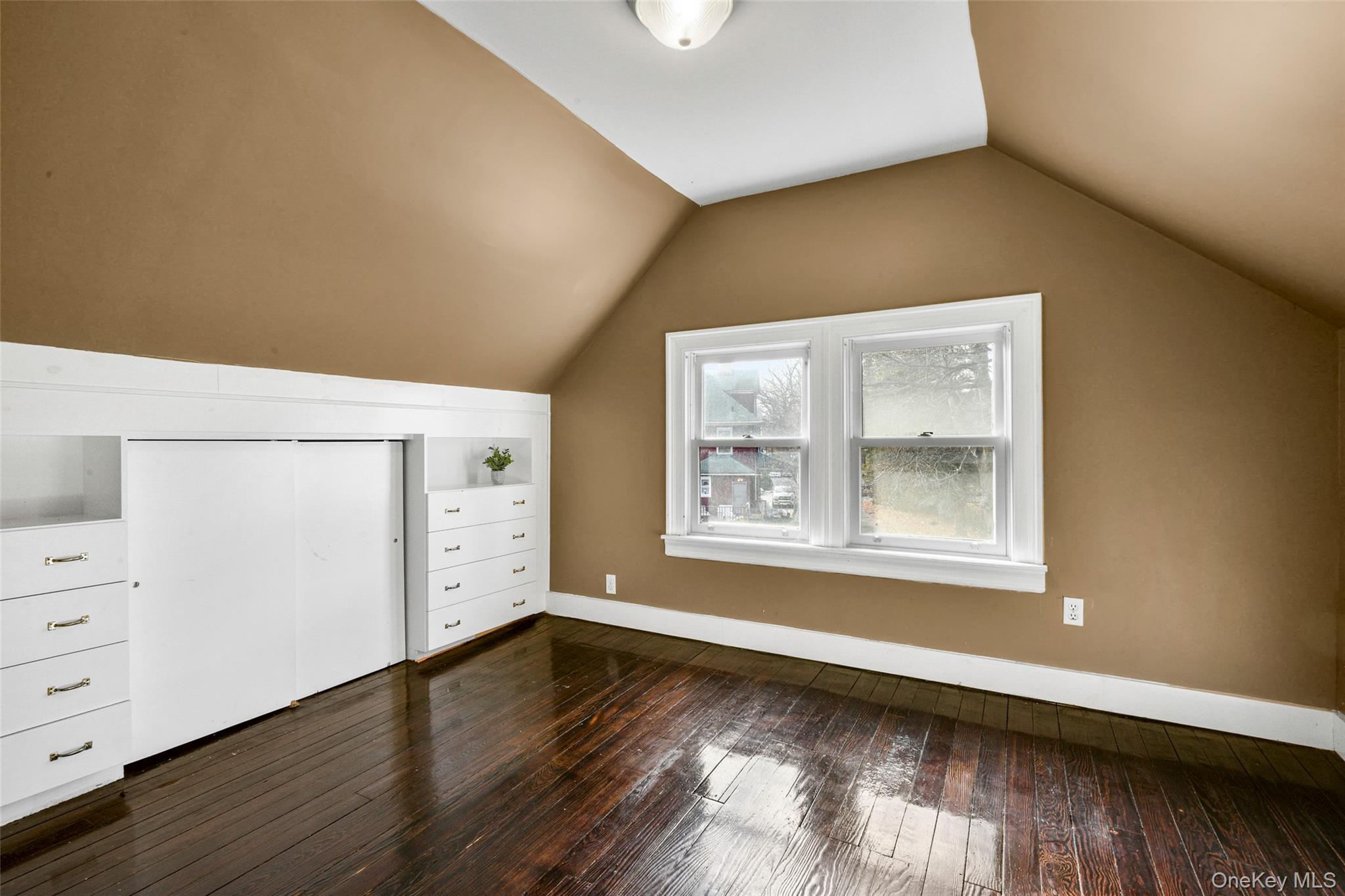 8 The Serpentine New Rochelle, NY 10801 - Photo 35 of 48 an empty room with wooden floor and window