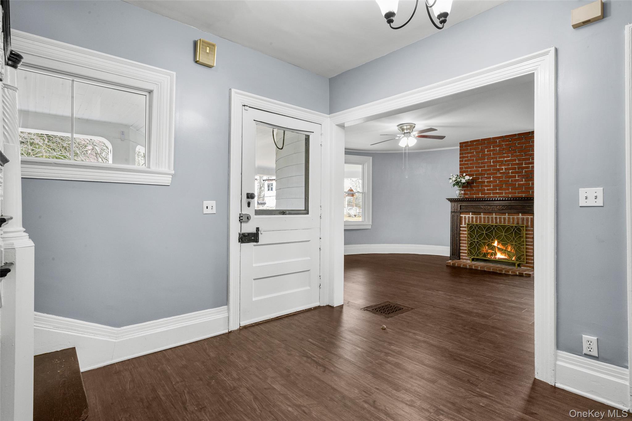 8 The Serpentine New Rochelle, NY 10801 - Photo 7 of 48 a view of a hallway with wooden floor and a fireplace