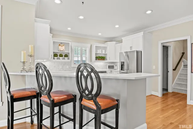 a kitchen with white cabinets and appliances