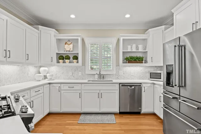 a kitchen with white cabinets and white appliances