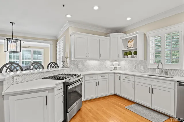a dining room with furniture window and wooden floor