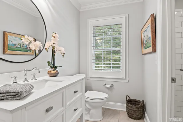 a bedroom with a large bed and a chandelier fan