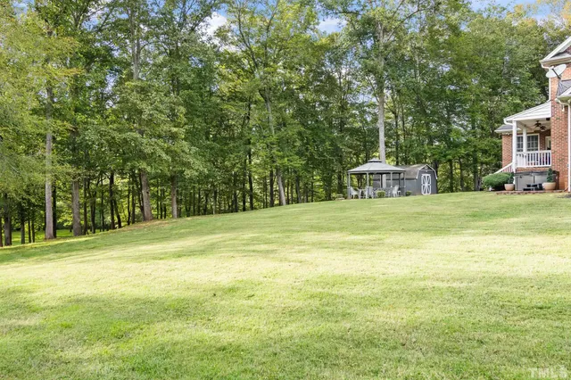 an aerial view of a house with a garden and trees