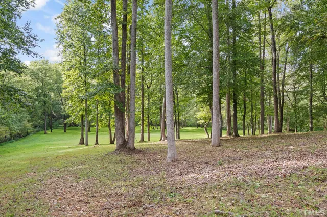 an aerial view of a house with backyard space and balcony