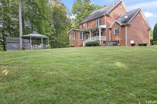 an aerial view of a house with garden space and a street view