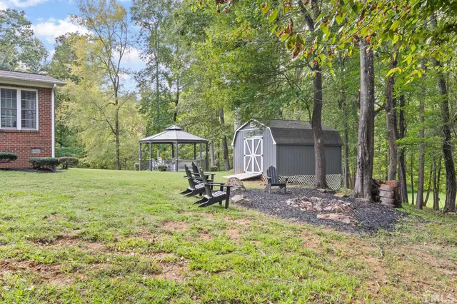 an aerial view of a house with a yard and outdoor seating
