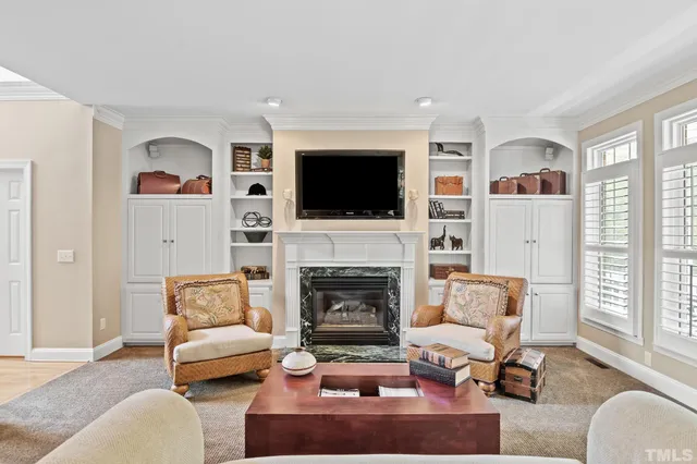 a living room with furniture a flat screen tv and a fireplace