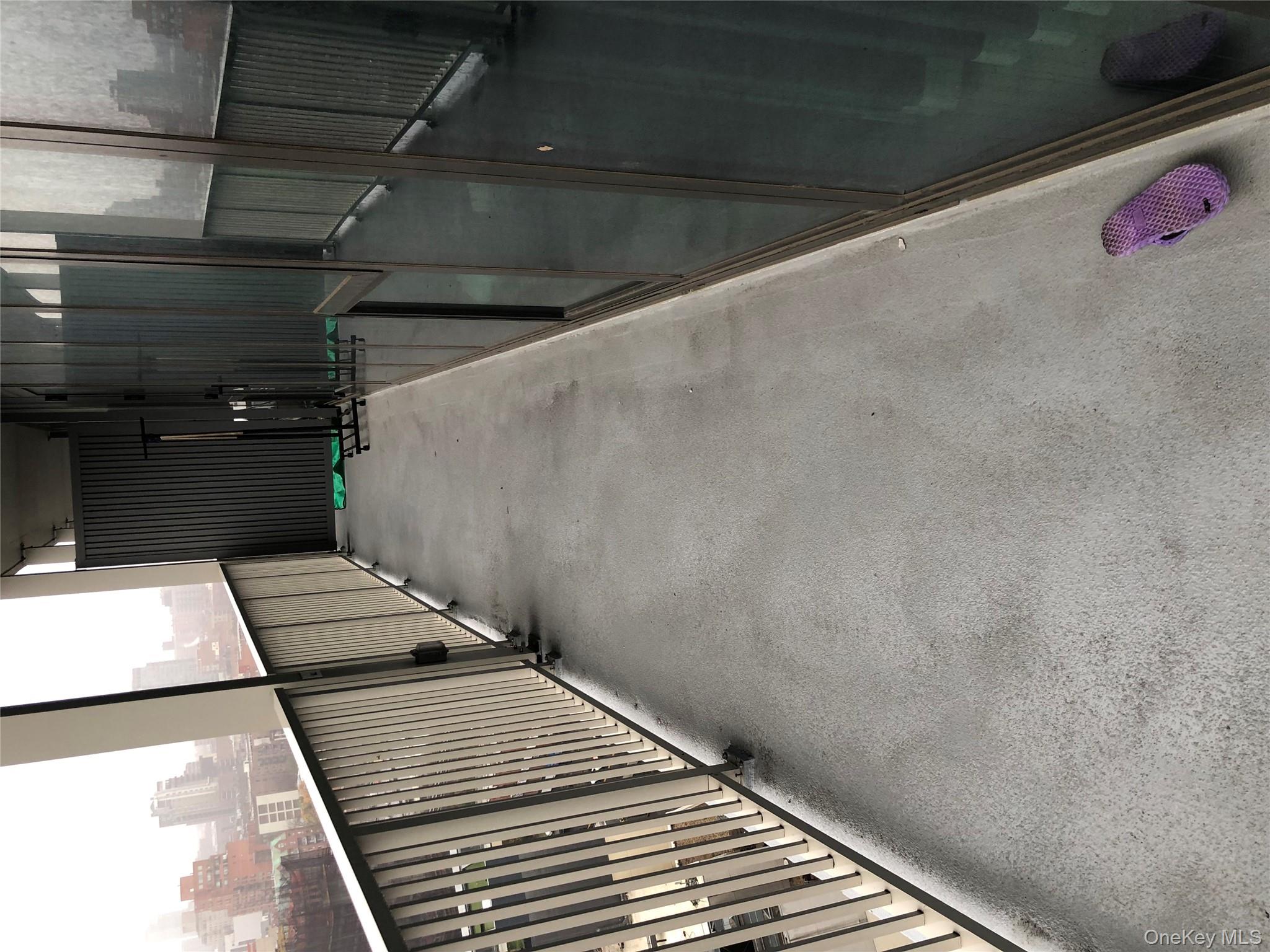 131-02 40th Road, Unit 17I Queens, NY 11354 - Photo 7 of 8 a balcony with wooden floor