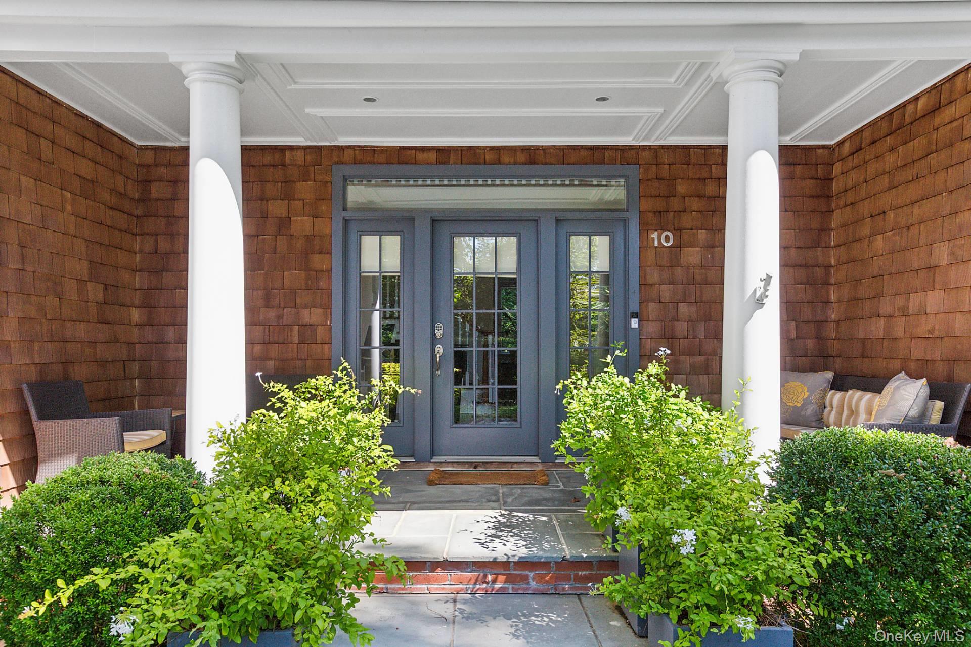 a view of a brick house with potted plants