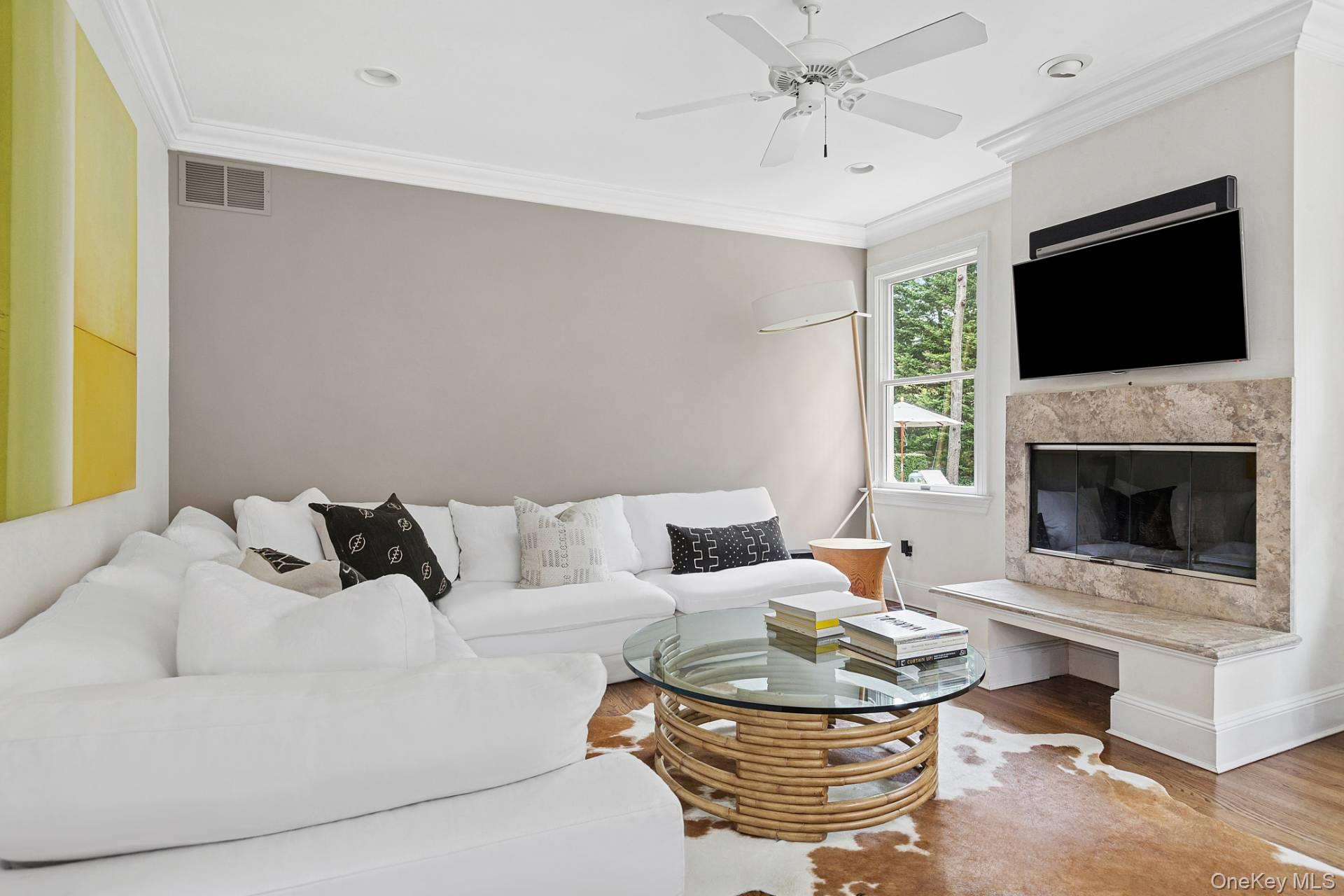10 Bayview Road Southampton, NY 11968 - Photo 15 of 39 a living room with furniture a fireplace and a flat screen tv