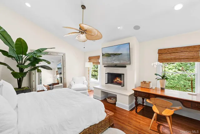 a dining room with furniture potted plants and wooden floor