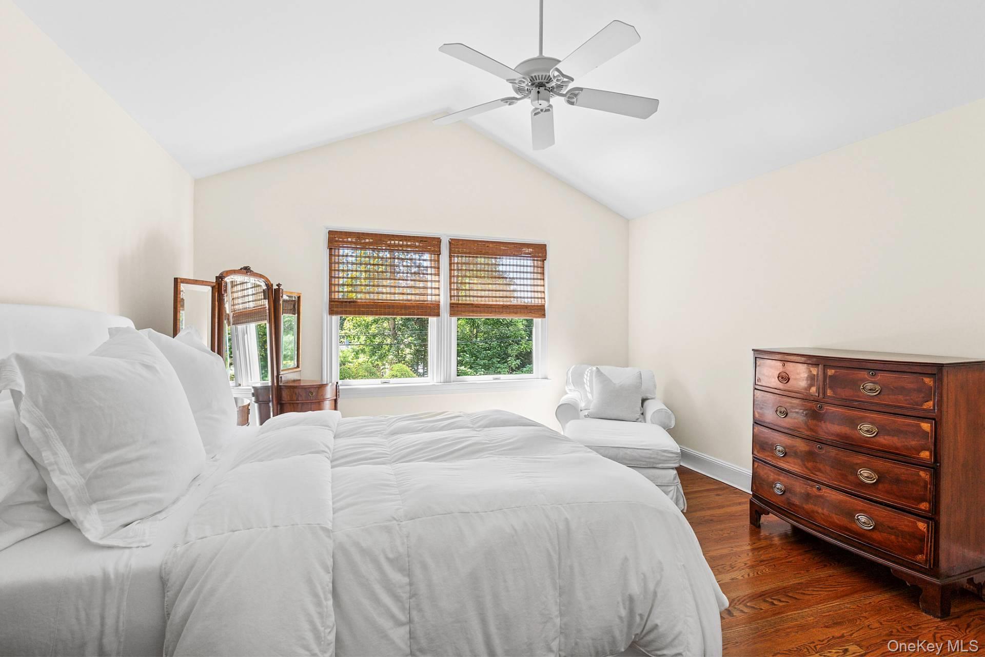 10 Bayview Road Southampton, NY 11968 - Photo 22 of 39 a bedroom with a bed a chandelier and a window