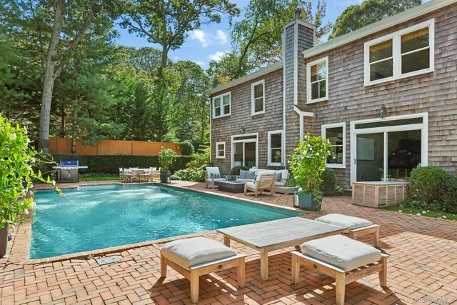 a view of a backyard with sitting area