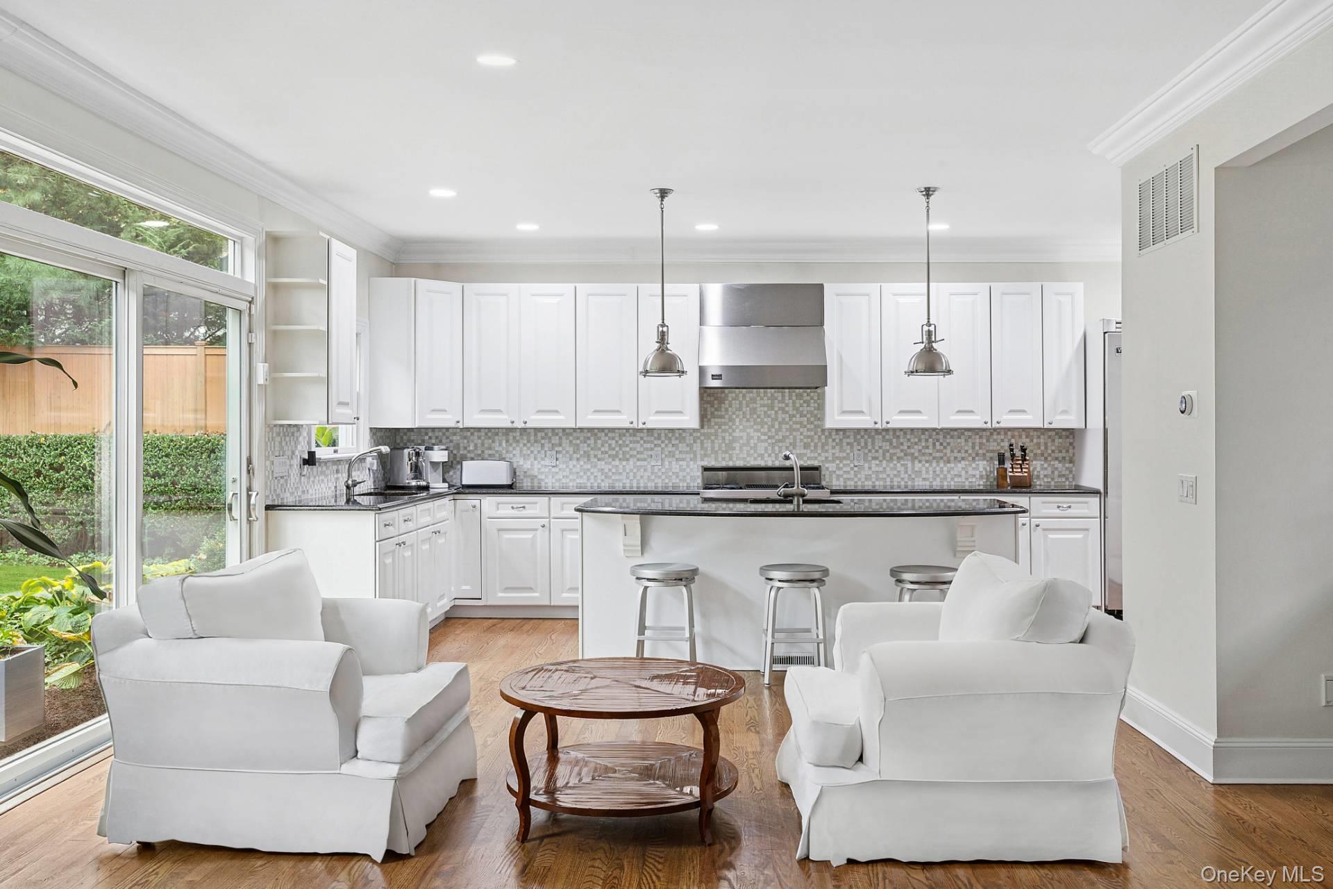 10 Bayview Road Southampton, NY 11968 - Photo 10 of 39 a kitchen with stainless steel appliances granite countertop a stove a sink and white cabinets