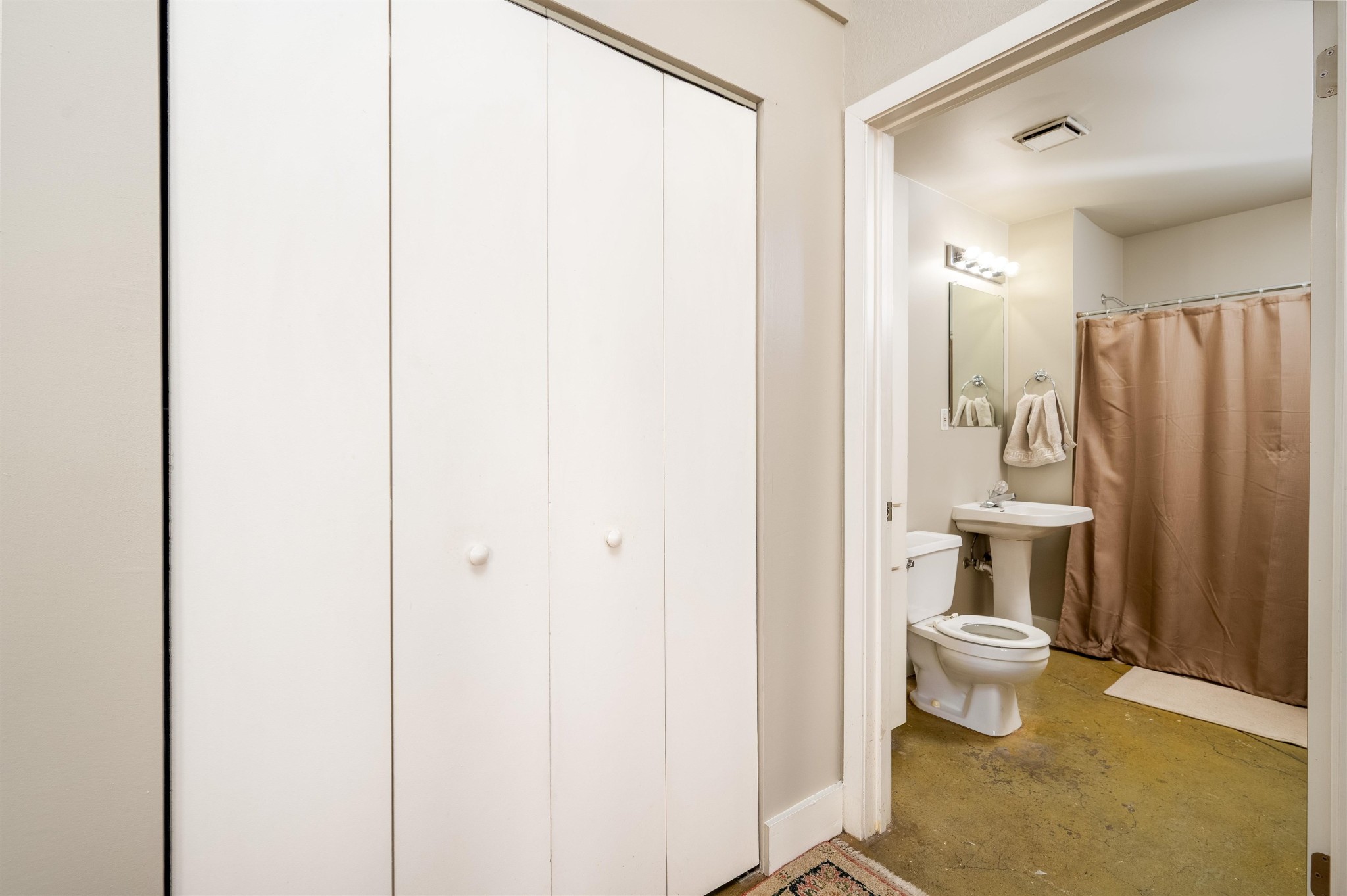 408 South Front Street, Unit 412 Memphis, TN 38103 - Photo 7 of 21 a bathroom with a sink a toilet and shower curtain