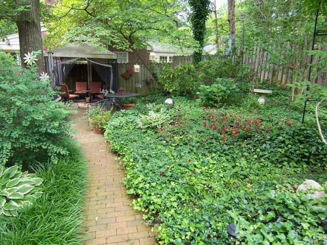 519 Gardner Street Raleigh, NC 27607 - Photo 11 of 12 Follow the red brick path to the back yard dining area, gazebo and lush garden natural areas. Hot tub is to the left of gazebo.