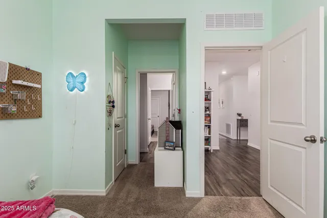 a view of a hallway with wooden floor and closet area