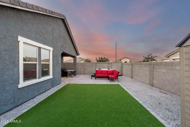 a view of a backyard with a garden and parking