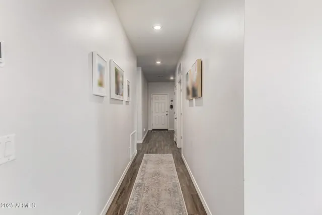 a view of a hallway with wooden floor