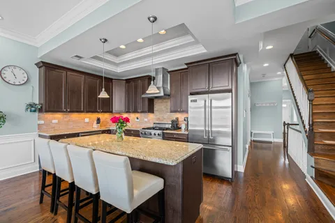 a kitchen with stainless steel appliances granite countertop a sink stove and cabinets