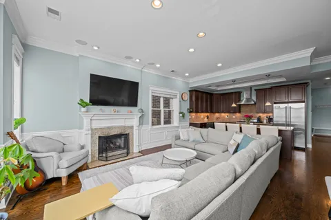 a living room with furniture a fireplace and a flat screen tv