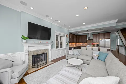 a living room with furniture a fireplace and a flat screen tv