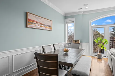 a kitchen with a table chairs sink and cabinets