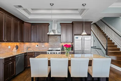 a living room with fireplace furniture and a large window