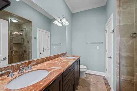 a balcony with wooden floor table and chairs