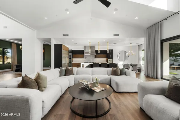 a kitchen with kitchen island granite countertop a sink cabinets and stainless steel appliances