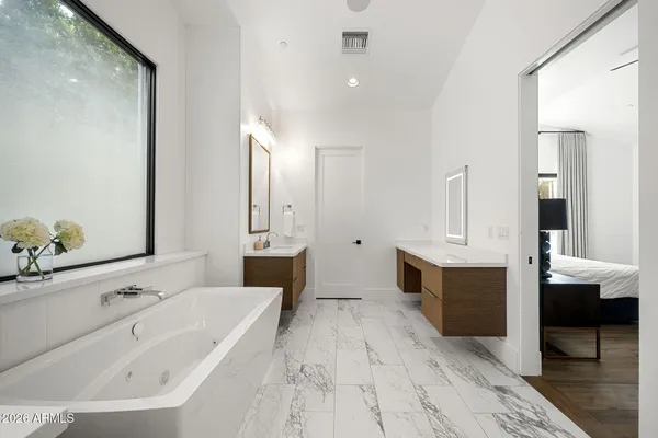 a bathroom with a granite countertop sink a toilet and mirror