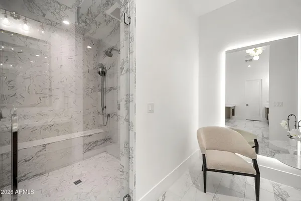 a swimming pool with lawn chairs and potted plants