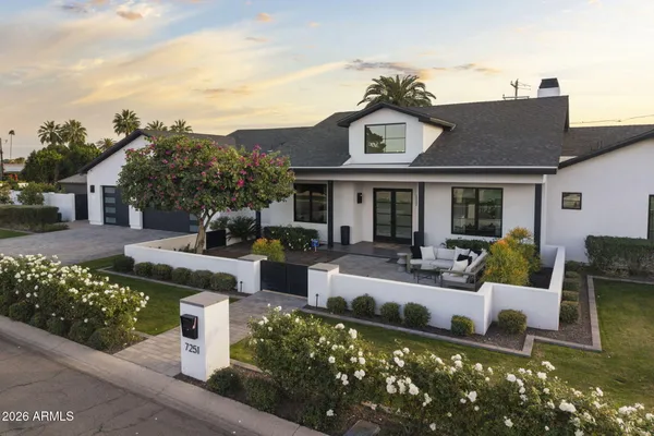 a view of a house with backyard sitting area and garden