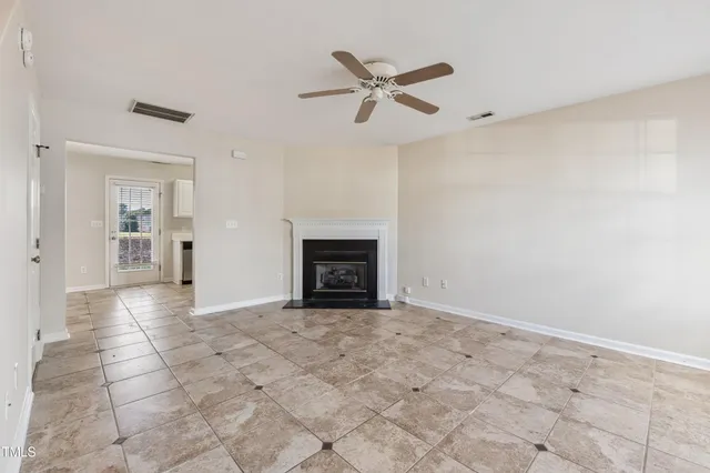 a view of a livingroom with a ceiling fan and window