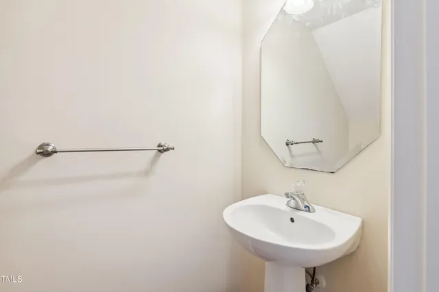 a bathroom with a sink a mirror and shower