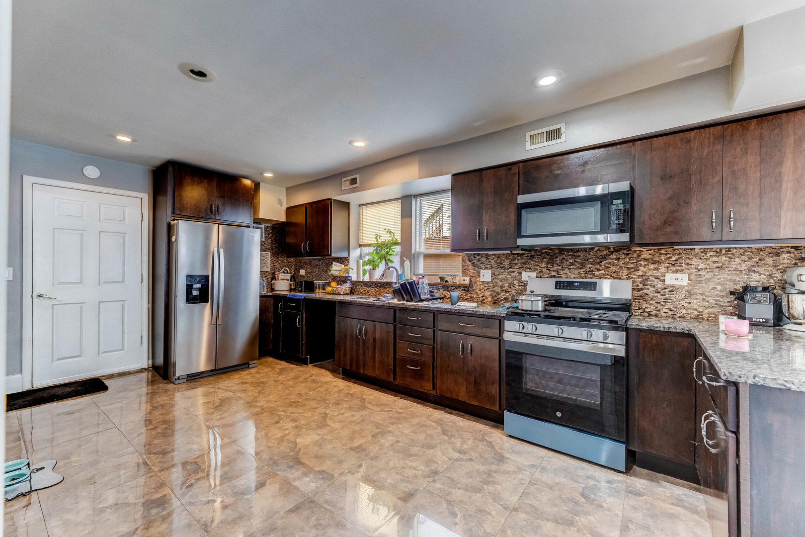 2328 West 19th Street Chicago, IL 60608 - Photo 3 of 31 a kitchen with stainless steel appliances granite countertop a stove refrigerator and microwave
