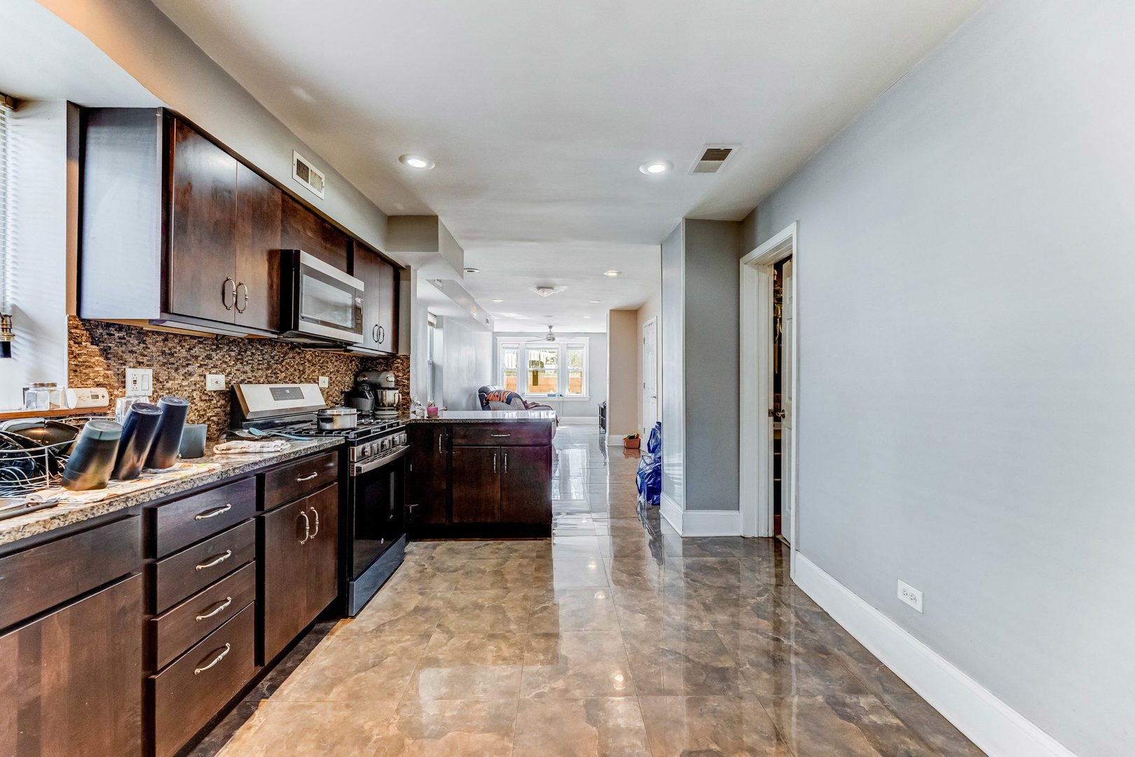 2328 West 19th Street Chicago, IL 60608 - Photo 5 of 31 a kitchen with stainless steel appliances granite countertop a refrigerator and a stove top oven